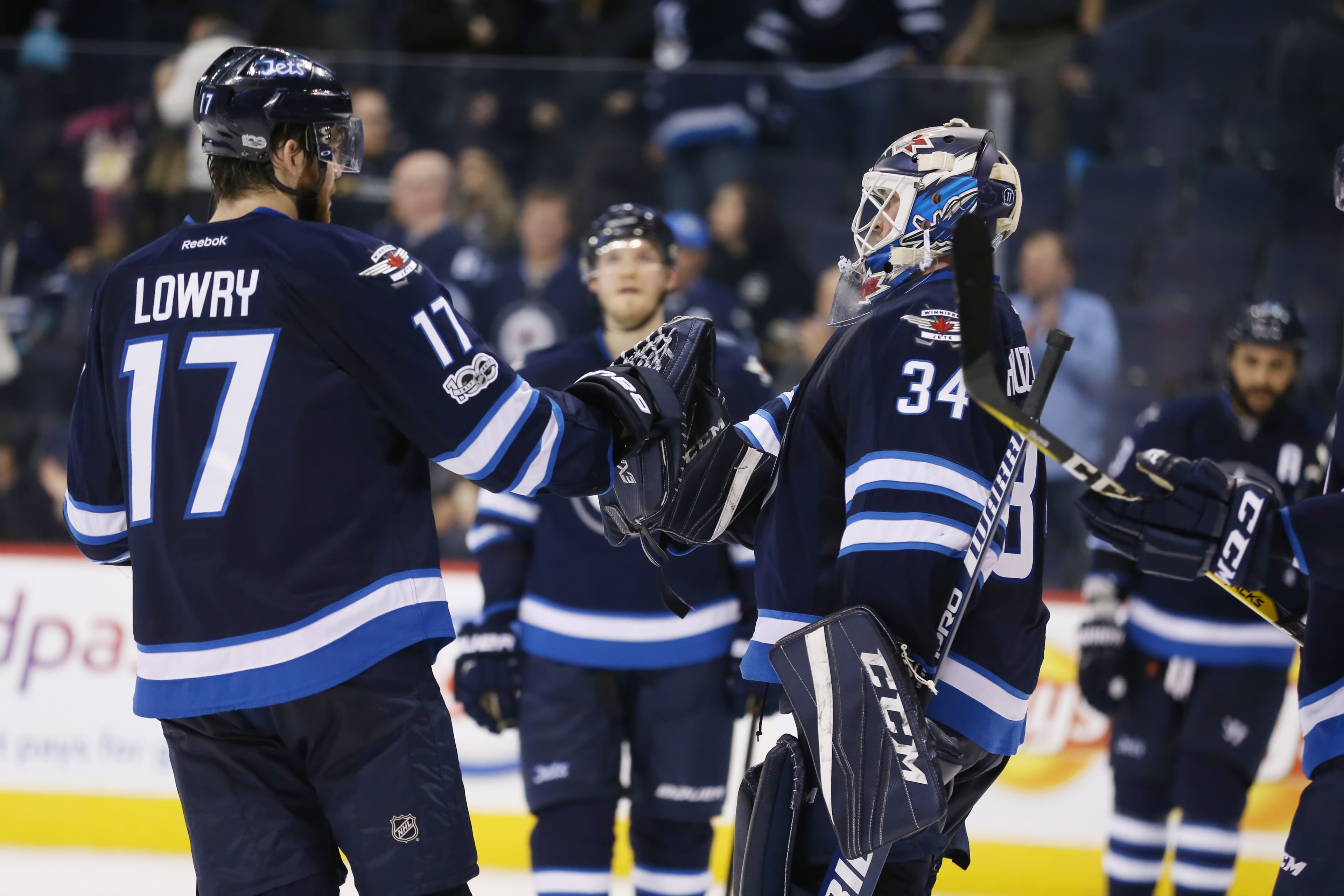 Mar 21, 2017; Winnipeg, Manitoba, CAN; Winnipeg Jets goalie Michael Hutchinson (34) celebrates with Jets defenseman Julian Melchiori (71) after defeating the Philadelphia Flyers 3-2 at MTS Centre. Mandatory Credit: Bruce Fedyck-USA TODAY Sports