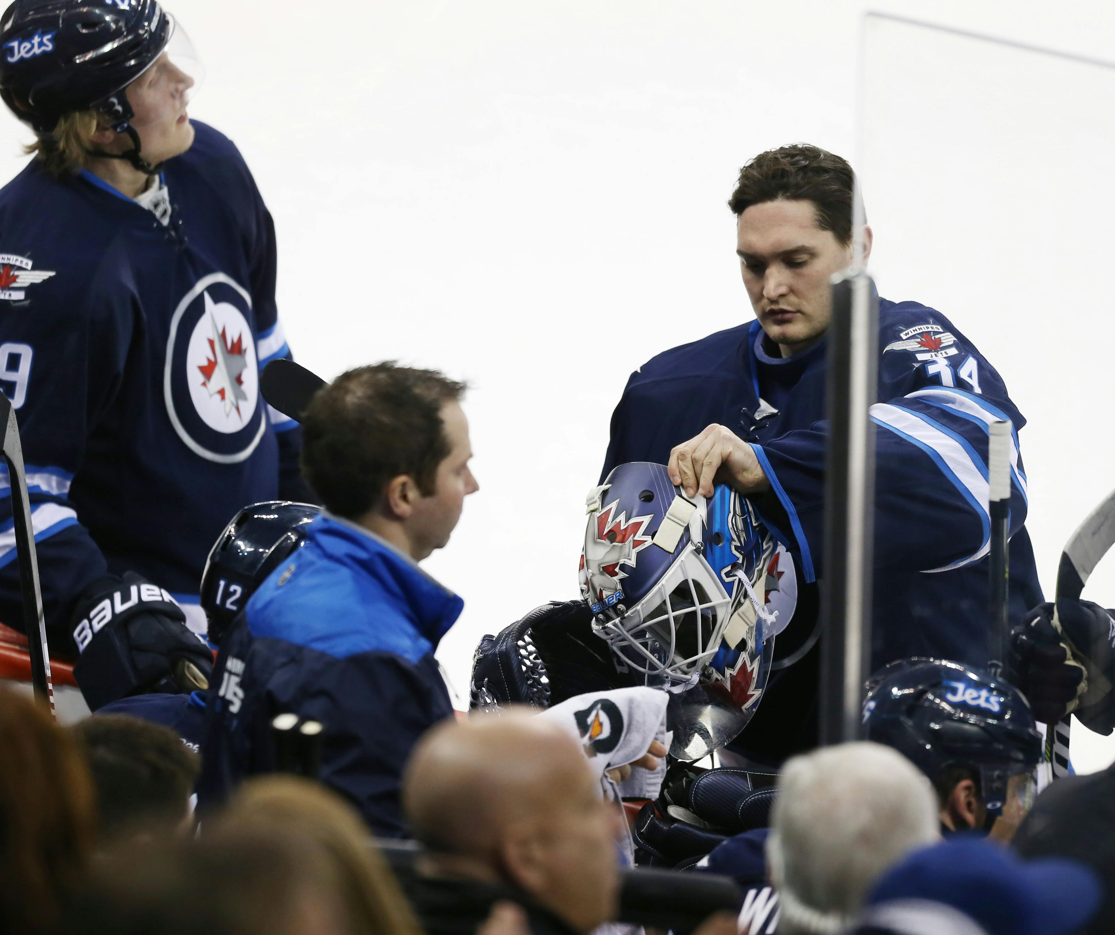 Winnipeg Jets goalie Michael Hutchinson (34) prepares to head to the net to replace Winnipeg Jets goalie Connor Hellebuyck (37) during the second period against the Minnesota Wild at MTS Centre.