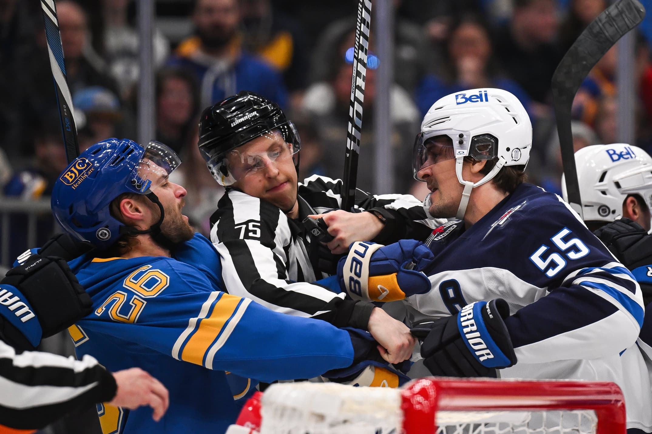 St. Louis Blues left wing Nathan Walker (26) and Winnipeg Jets center Mark Scheifele (55) get physical during the second period at Enterprise Center