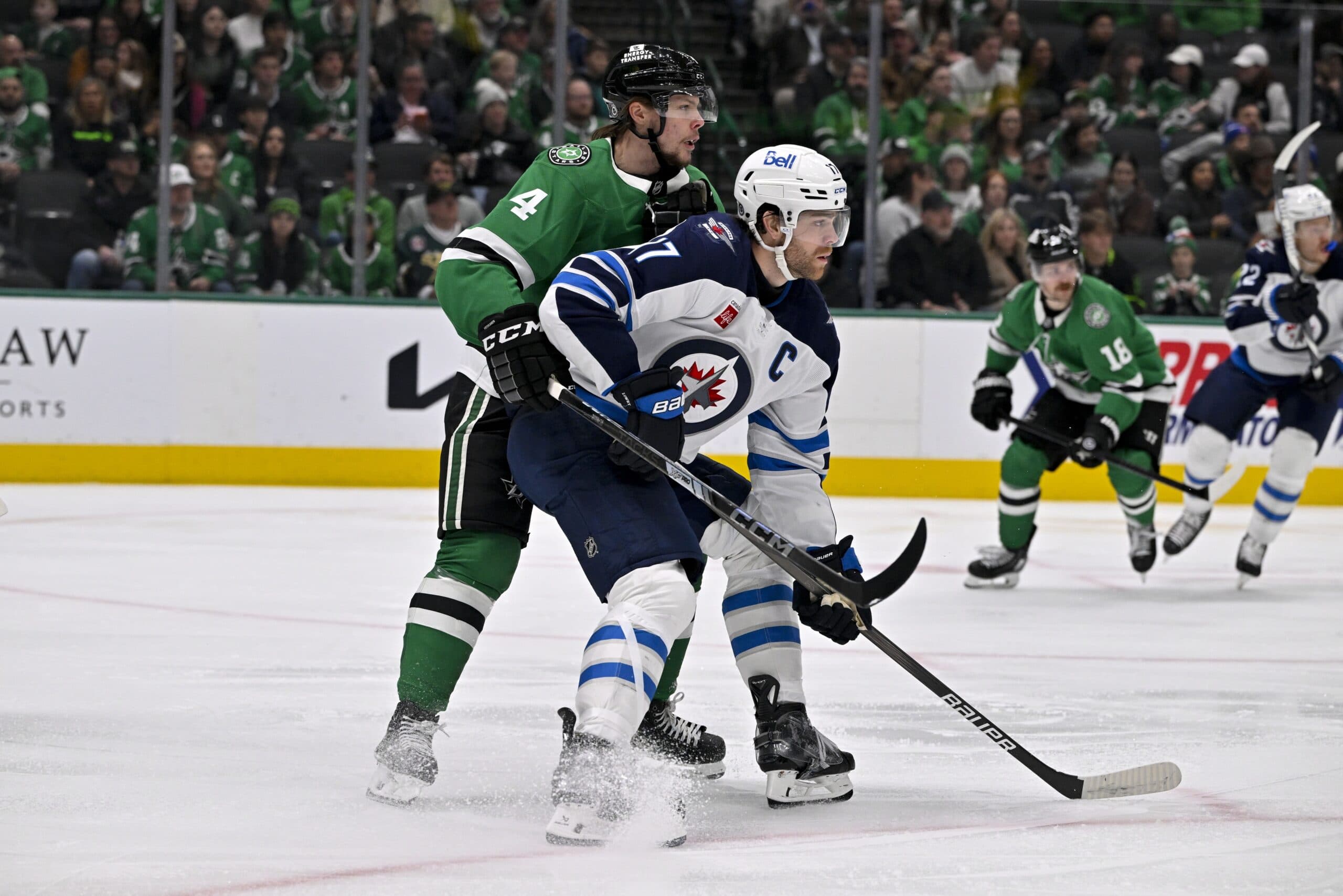 Dallas Stars defenseman Miro Heiskanen (4) and Winnipeg Jets center Adam Lowry (17) in action during the game between the Dallas Stars and the Winnipeg Jets at American Airlines Center