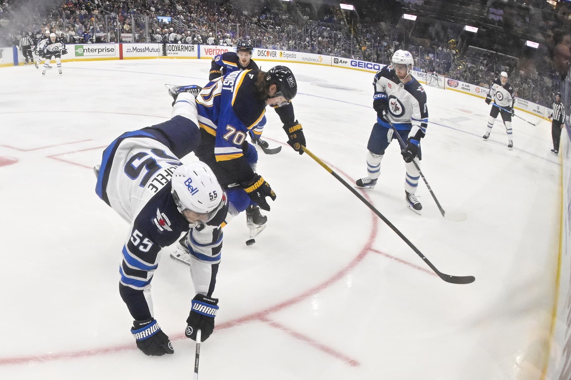 St. Louis Blues center Oskar Sundqvist (70) checks Winnipeg Jets center Mark Scheifele (55) during the first period in game three of the first round of the 2025 Stanley Cup Playoffs at Enterprise Center.