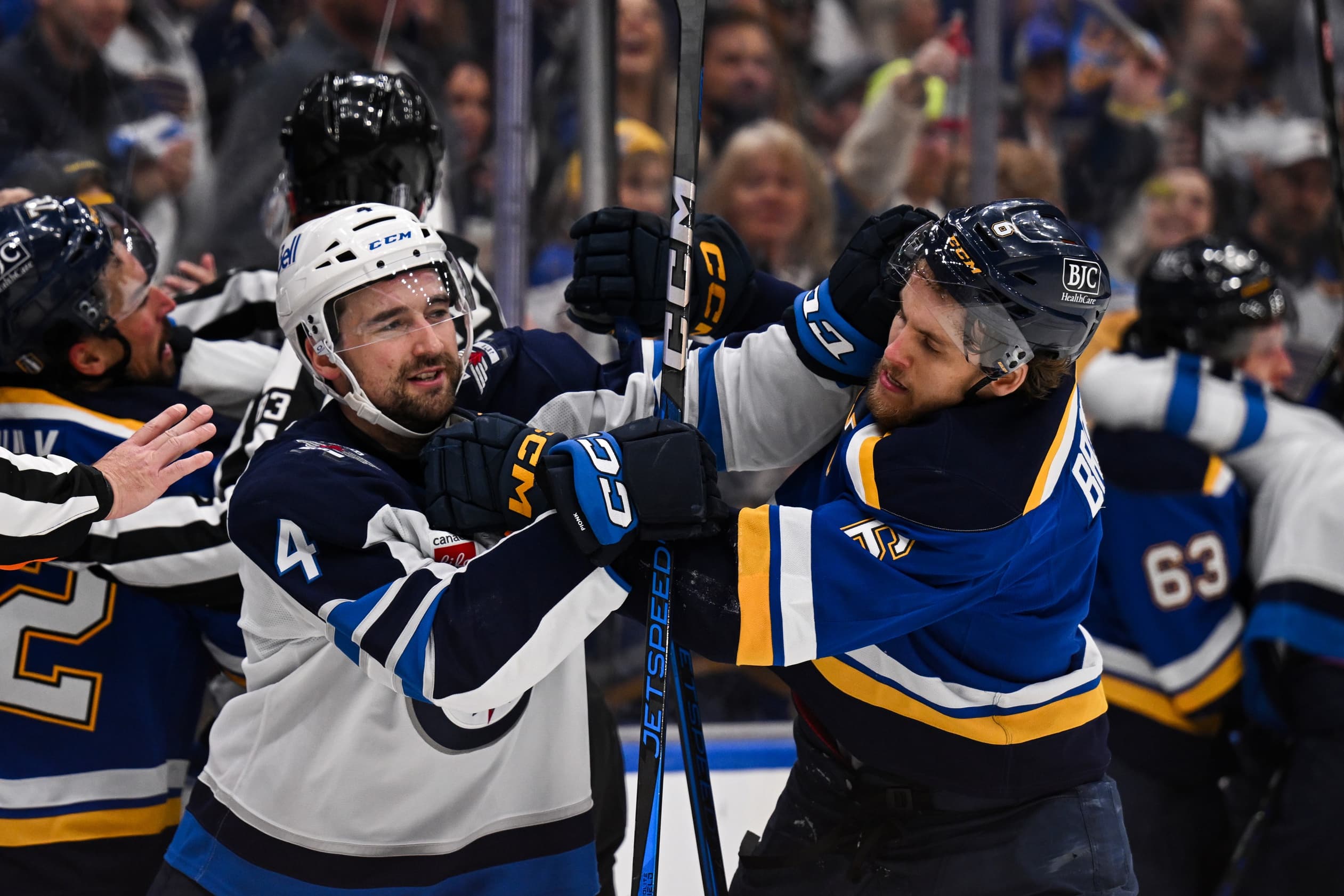 Winnipeg Jets defenseman Neal Pionk (4) and St. Louis Blues defenseman Philip Broberg (6) get physical during the third period in game six of the first round of the 2025 Stanley Cup Playoffs at Enterprise Center.