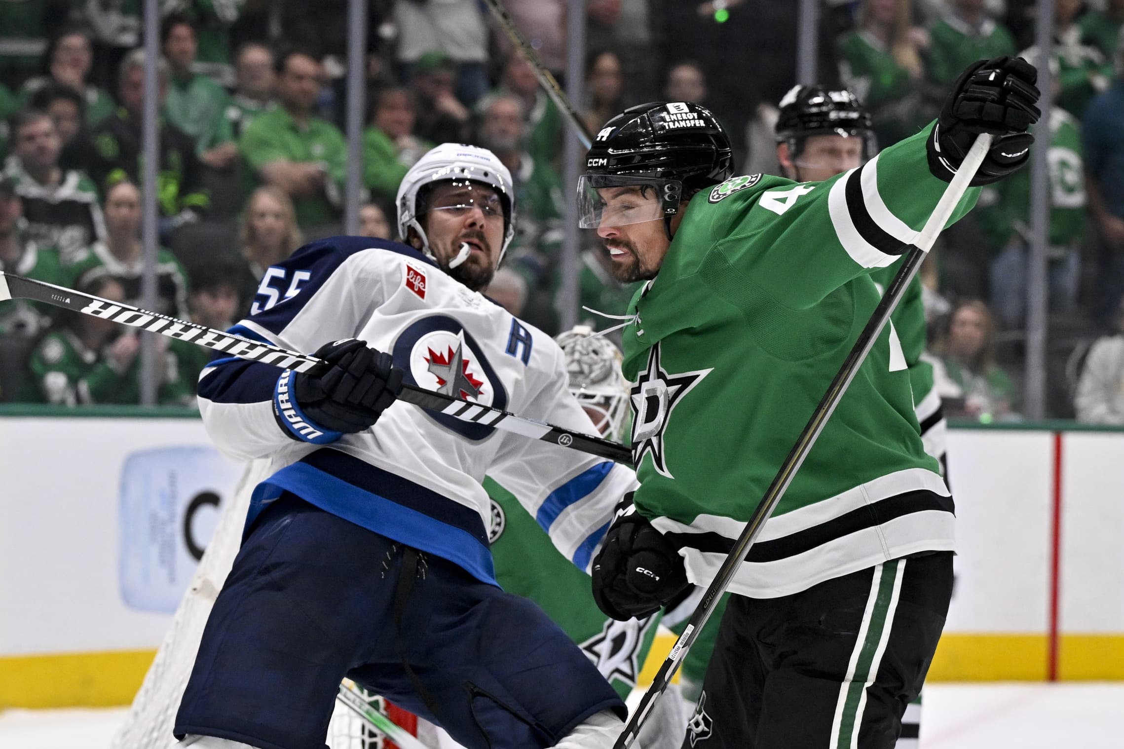Dallas Stars defenseman Cody Ceci (44) checks Winnipeg Jets center Mark Scheifele (55) during the third period in game four of the second round of the 2025 Stanley Cup Playoffs at American Airlines Center.